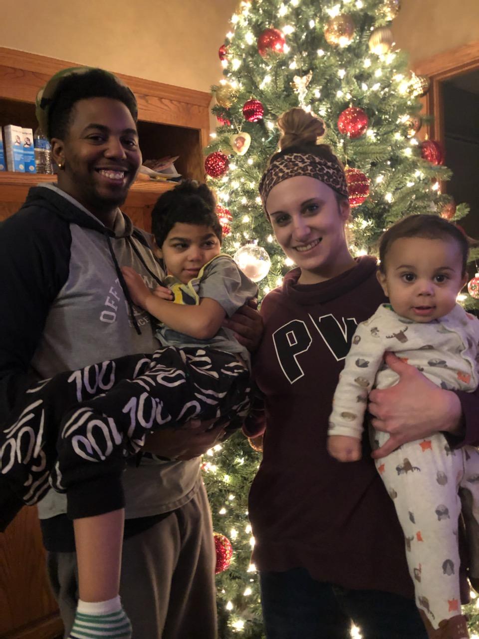 Kylen Family in Front of Xmas Tree Wish Pres