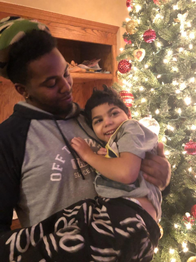 Kylen w Dad in Front of Xmas Tree Wish Pres