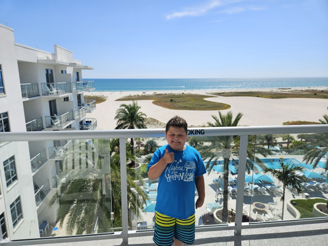 Archer on balcony of condo