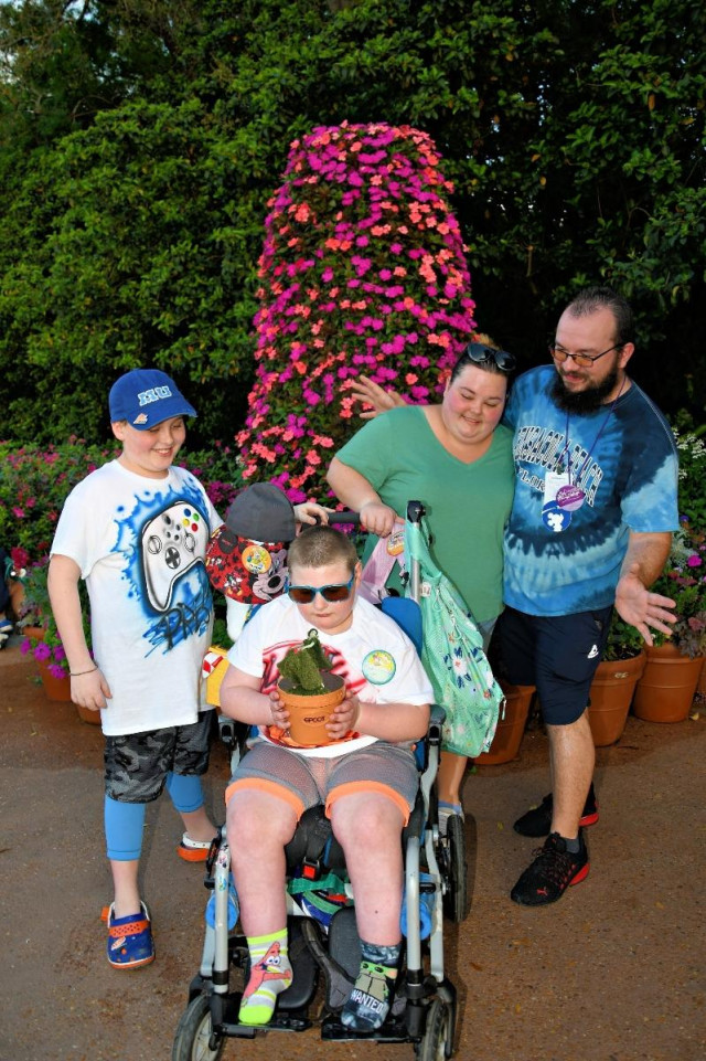 Blaine Holding a Plant with family