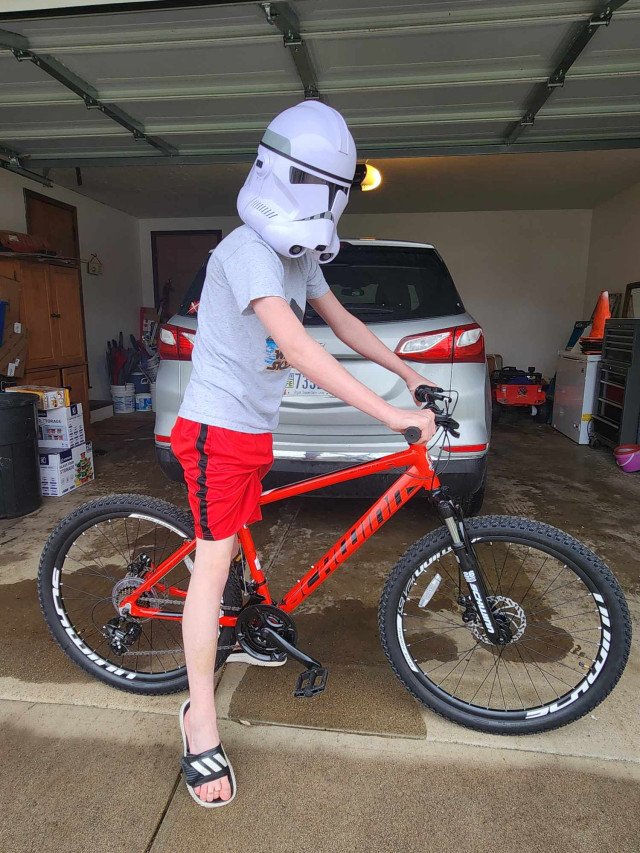 Micah on Bike with Helmet