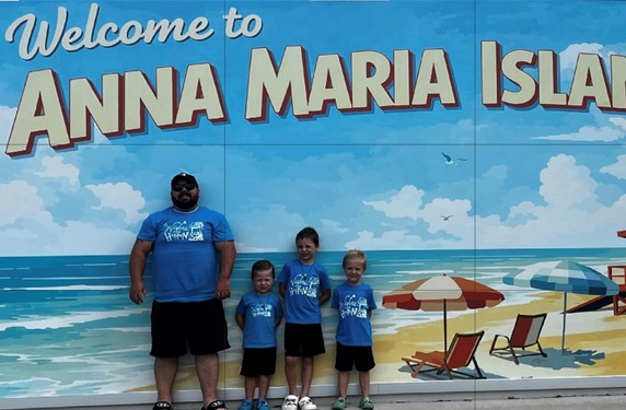Corrected Pic Dad on Beach under sign w boys