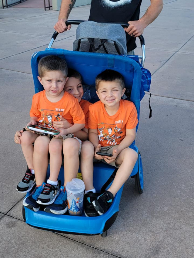 3 boys strolling in a stroller