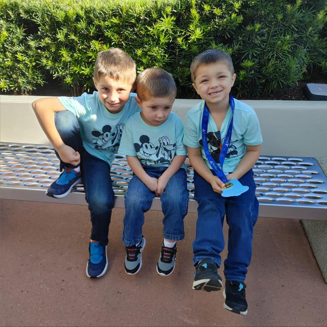 Boy chilaxin on bench at Disney